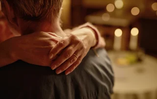 A woman embracing her husband