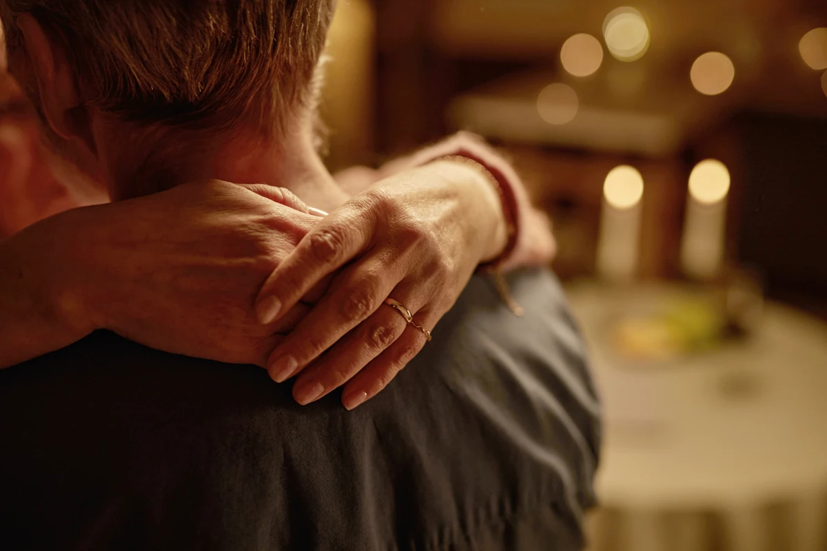 A woman embracing her husband